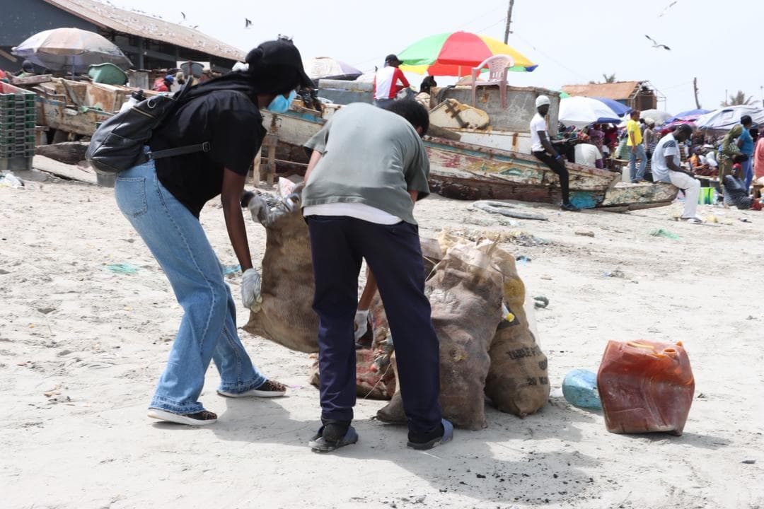 SMF volunteers working together at a community cleanup in The Gambia